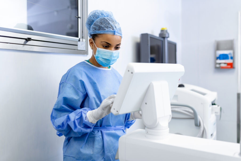 female surgeon with surgical mask at operating room using 3d image guided surgery machine