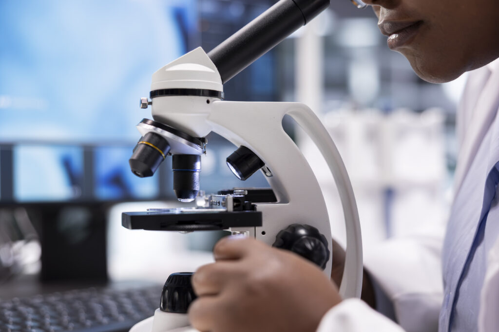 microscope close up of specimen tray in lab studied by expert